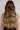 Woman with long, voluminous Chocolate Dark Brown & Honey Blonde hair from Deluxe Line clip-ins – Rubin Extensions®